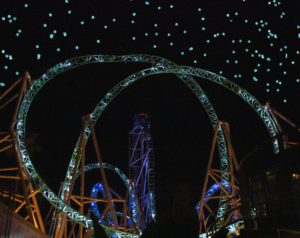 photo of lighted tracks of a roller coaster at night